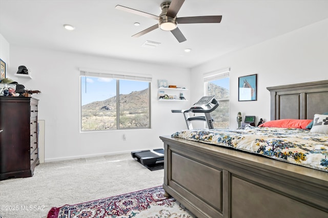 bedroom featuring light colored carpet, visible vents, baseboards, and multiple windows