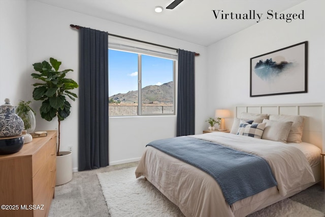 bedroom featuring light carpet, a mountain view, and baseboards