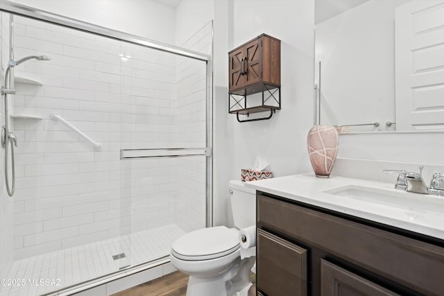 bathroom featuring a stall shower, a baseboard radiator, vanity, and toilet