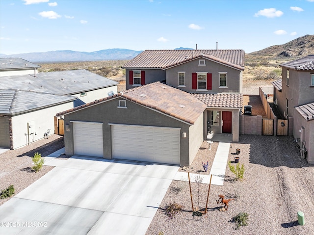 view of front of property featuring a mountain view, a tiled roof, and stucco siding