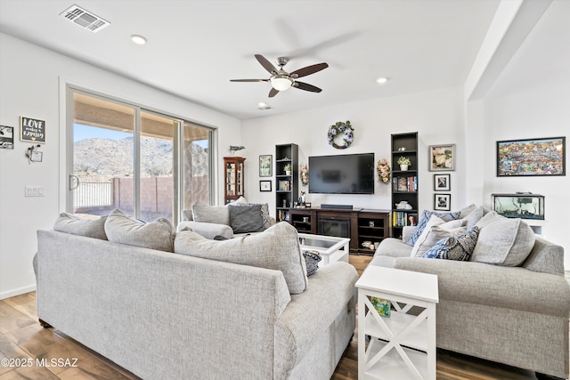 living room featuring wood finished floors, visible vents, and recessed lighting
