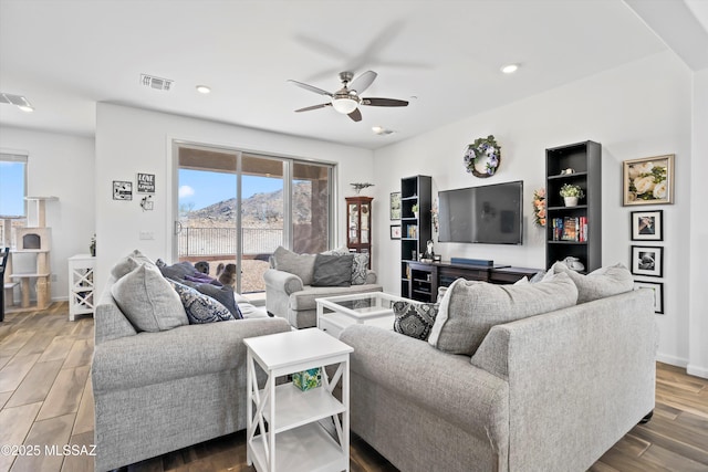 living area featuring dark wood-style flooring, recessed lighting, visible vents, a ceiling fan, and baseboards