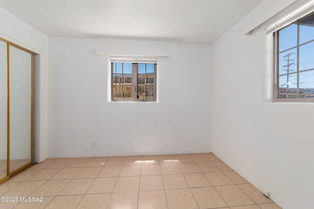 interior space featuring light tile patterned flooring and a closet