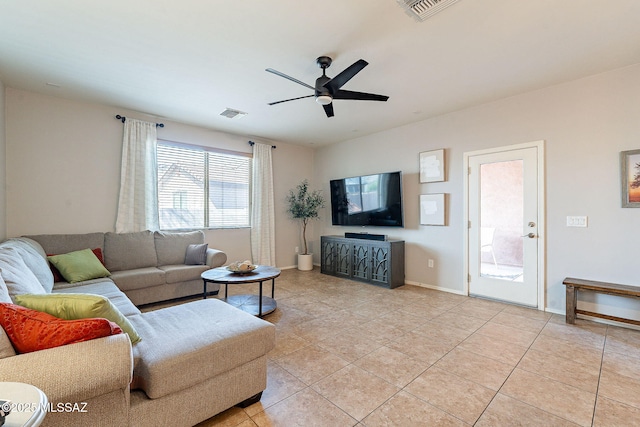 living room featuring visible vents, light tile patterned flooring, and a ceiling fan