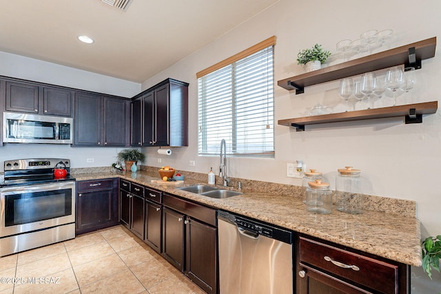 6266 W Scotch Pine Ln, Tucson, AZ 85743 - kitchen with appliances with stainless steel finishes, a sink, light tile patterned floors, light stone counters, and recessed lighting
