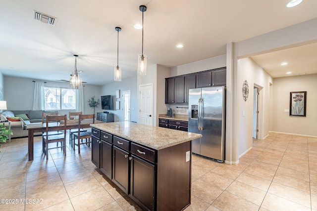 kitchen featuring visible vents, stainless steel fridge, light tile patterned flooring, and open floor plan