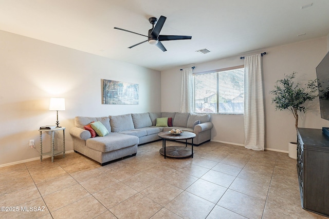 living area featuring light tile patterned floors, visible vents, baseboards, and a ceiling fan