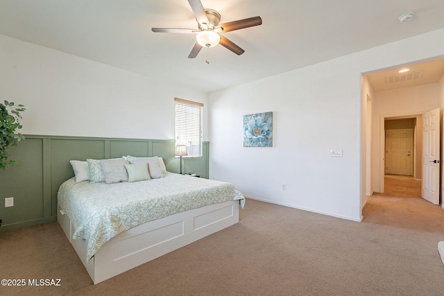 bedroom featuring light carpet, visible vents, and a ceiling fan