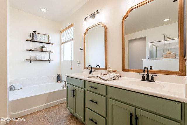 bathroom featuring tile patterned floors, a garden tub, double vanity, and a sink