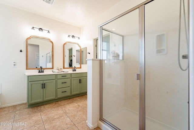 full bath with double vanity, tile patterned flooring, a shower stall, and a sink