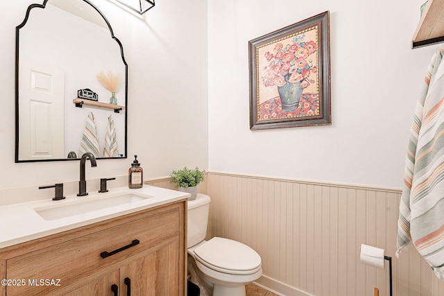 6266 W Scotch Pine Ln, Tucson, AZ 85743 - bathroom featuring toilet, vanity, and a wainscoted wall