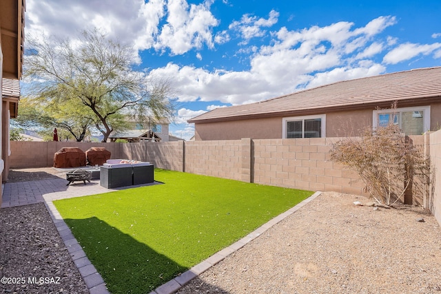 view of yard with an outdoor fire pit, a fenced backyard, and a patio area