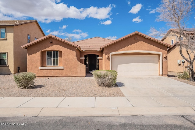 mediterranean / spanish-style home featuring stucco siding, an attached garage, driveway, and a tiled roof