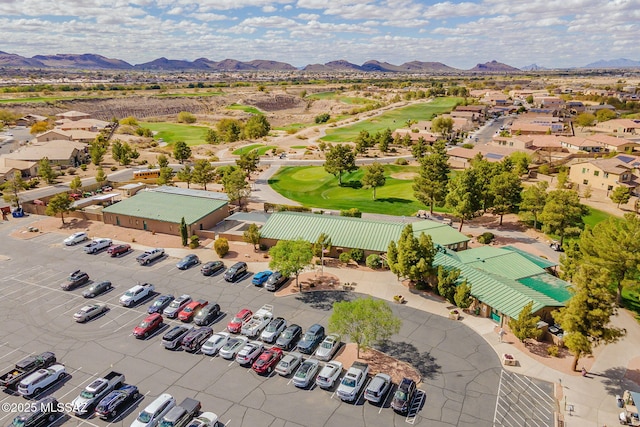 aerial view with view of golf course and a mountain view