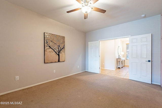 unfurnished bedroom featuring baseboards, light colored carpet, and ceiling fan