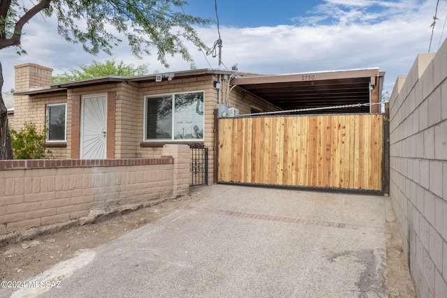 view of side of home with a carport