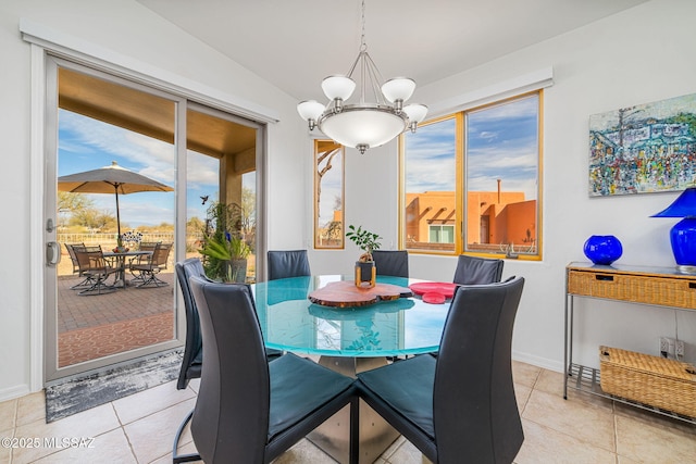 dining room with light tile patterned flooring and a chandelier