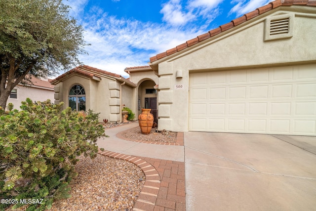 mediterranean / spanish house featuring a garage