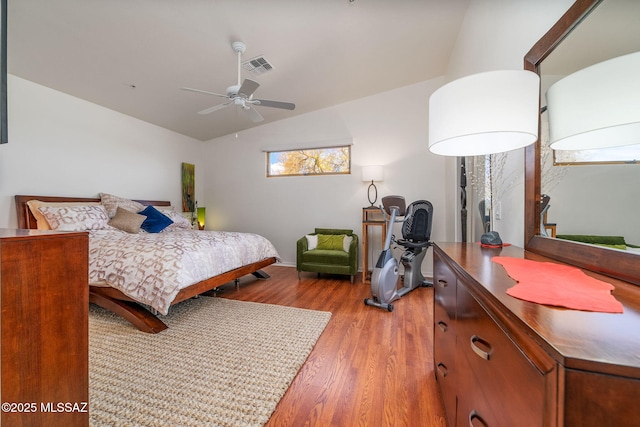 bedroom with lofted ceiling, hardwood / wood-style floors, and ceiling fan