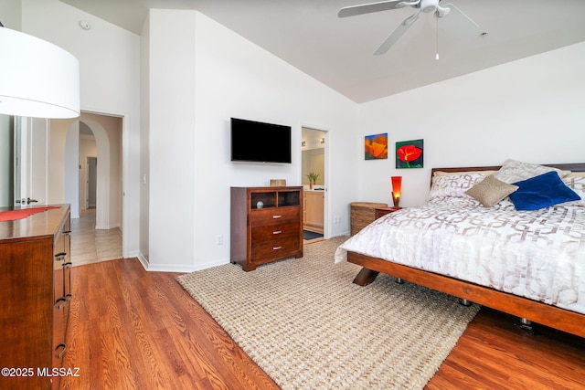 bedroom featuring wood-type flooring and high vaulted ceiling