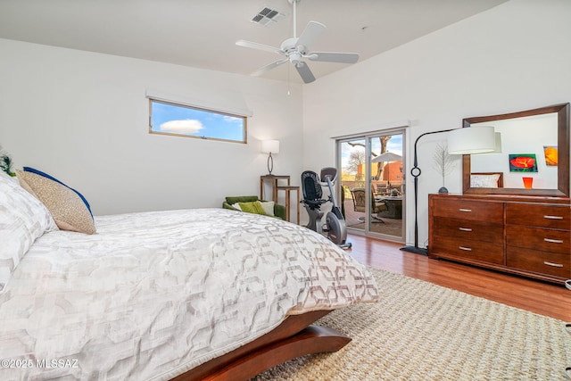 bedroom with multiple windows, access to outside, ceiling fan, and light wood-type flooring