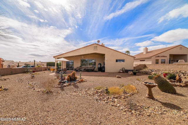 back of property with a patio