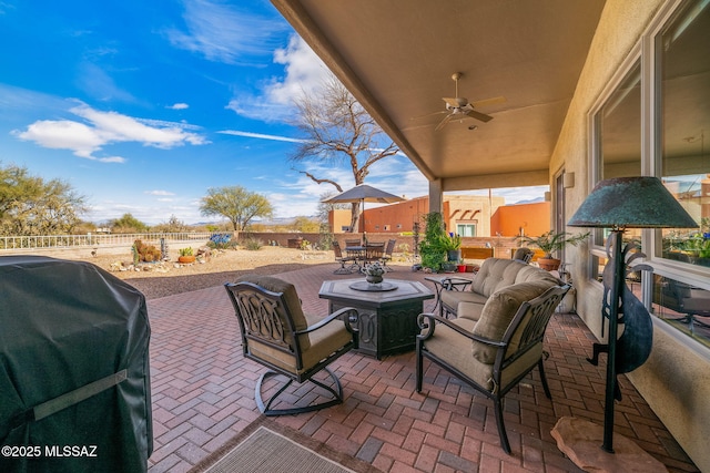 view of patio featuring ceiling fan, a grill, and an outdoor hangout area