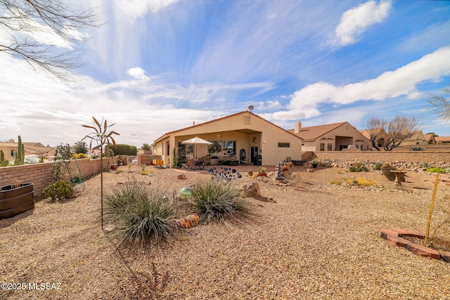 rear view of property featuring a patio area