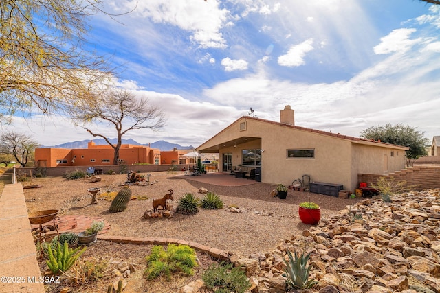 rear view of property featuring a patio area