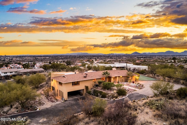 aerial view at dusk featuring a mountain view