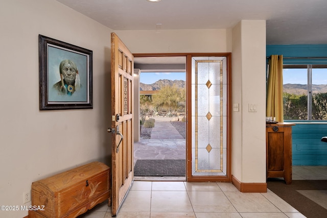 foyer entrance featuring a mountain view, plenty of natural light, and light tile patterned floors