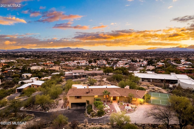 aerial view at dusk featuring a mountain view