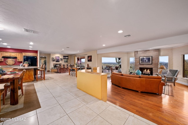 tiled living room featuring a fireplace