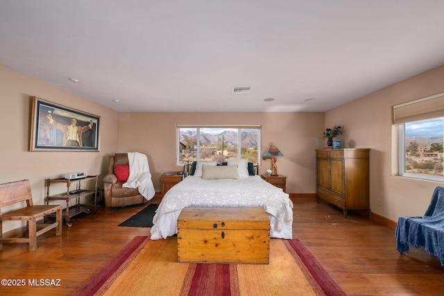 bedroom featuring wood-type flooring and multiple windows