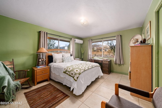 bedroom featuring a wall mounted AC and light tile patterned floors