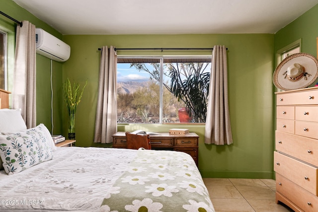 bedroom with a wall mounted AC and light tile patterned flooring