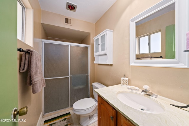 bathroom with vanity, toilet, and an enclosed shower