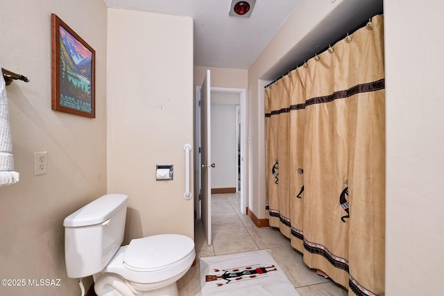 bathroom with tile patterned floors and toilet