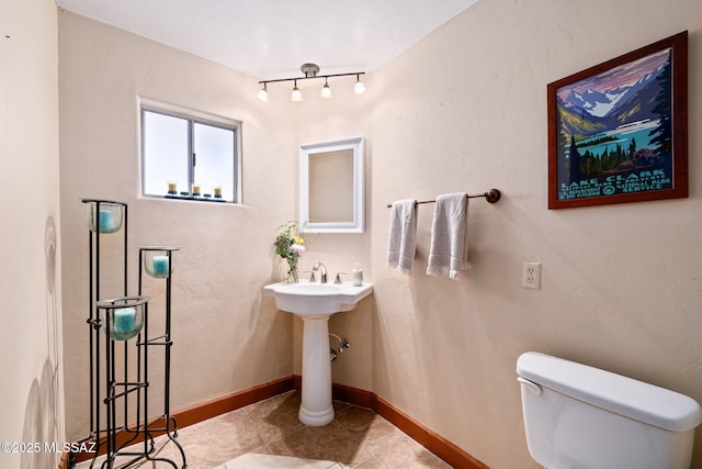 bathroom featuring tile patterned flooring and toilet