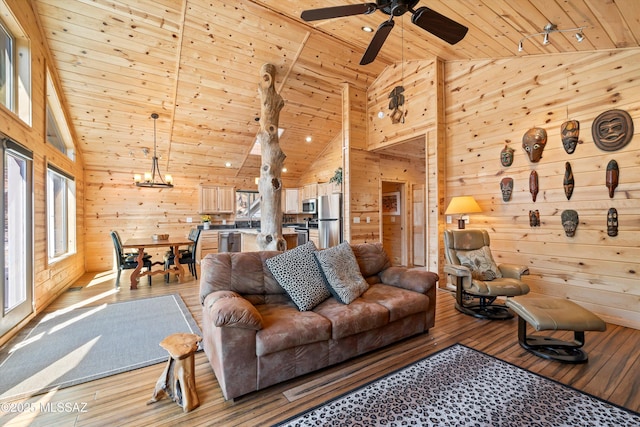 living room with wooden ceiling, wood walls, and light wood-style flooring