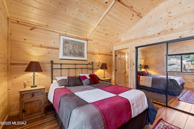 bedroom featuring vaulted ceiling, wood walls, wooden ceiling, and hardwood / wood-style flooring
