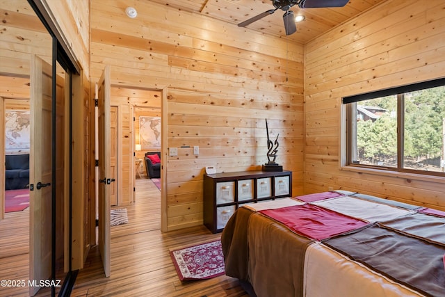 bedroom featuring wood ceiling, wooden walls, and hardwood / wood-style flooring