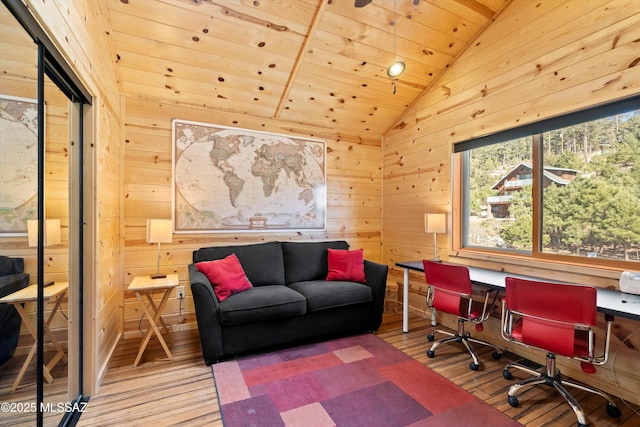 office space with wood ceiling, vaulted ceiling, wood walls, and hardwood / wood-style flooring