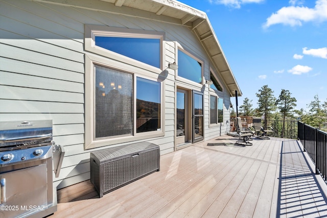 wooden deck with a grill