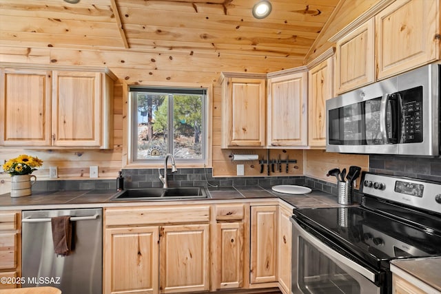 kitchen with wood ceiling, stainless steel appliances, a sink, and light brown cabinetry
