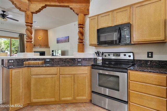 kitchen with stainless steel electric range oven, dark stone countertops, light tile patterned floors, ceiling fan, and light brown cabinets