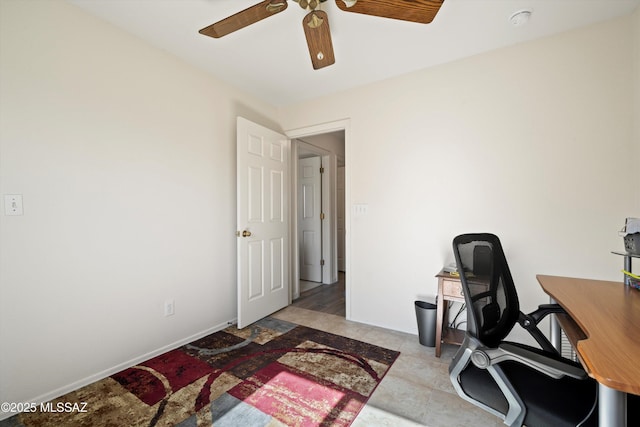 office featuring ceiling fan and baseboards