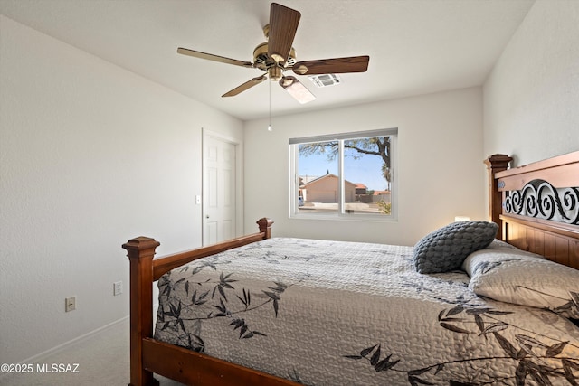 carpeted bedroom with a ceiling fan, visible vents, and baseboards