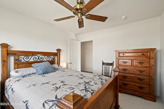 bedroom with a ceiling fan and carpet