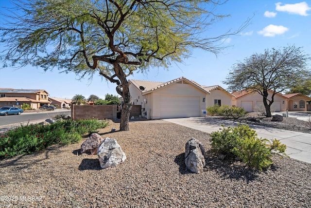 view of front of house featuring a residential view, driveway, an attached garage, and stucco siding